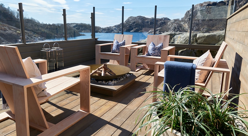 Eventyrlig oppussing, episode 3, sesong 7. Uteområde med terrasse, glassrekkverk og solide utemøbler i tre.